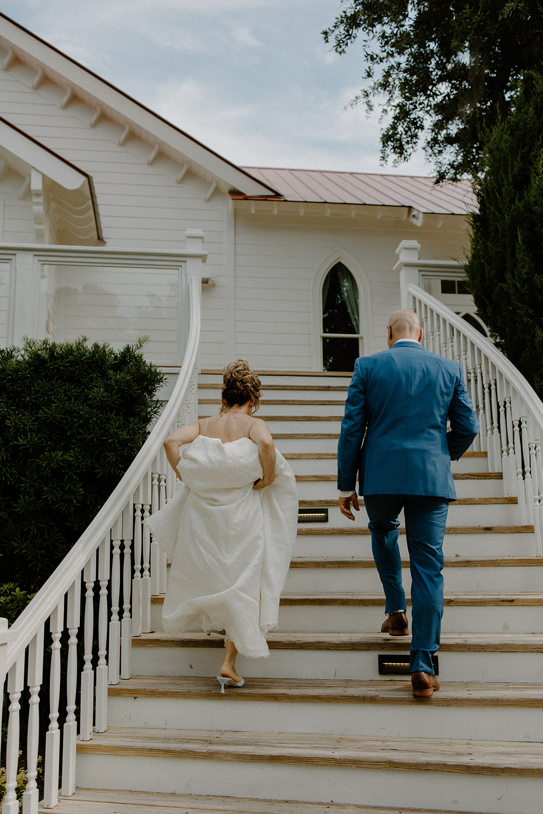 the couple walking up the chapel stairs