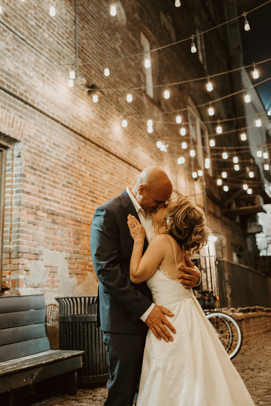 the couple kissing under lights to celebrate their Savannah Georgia Elopement