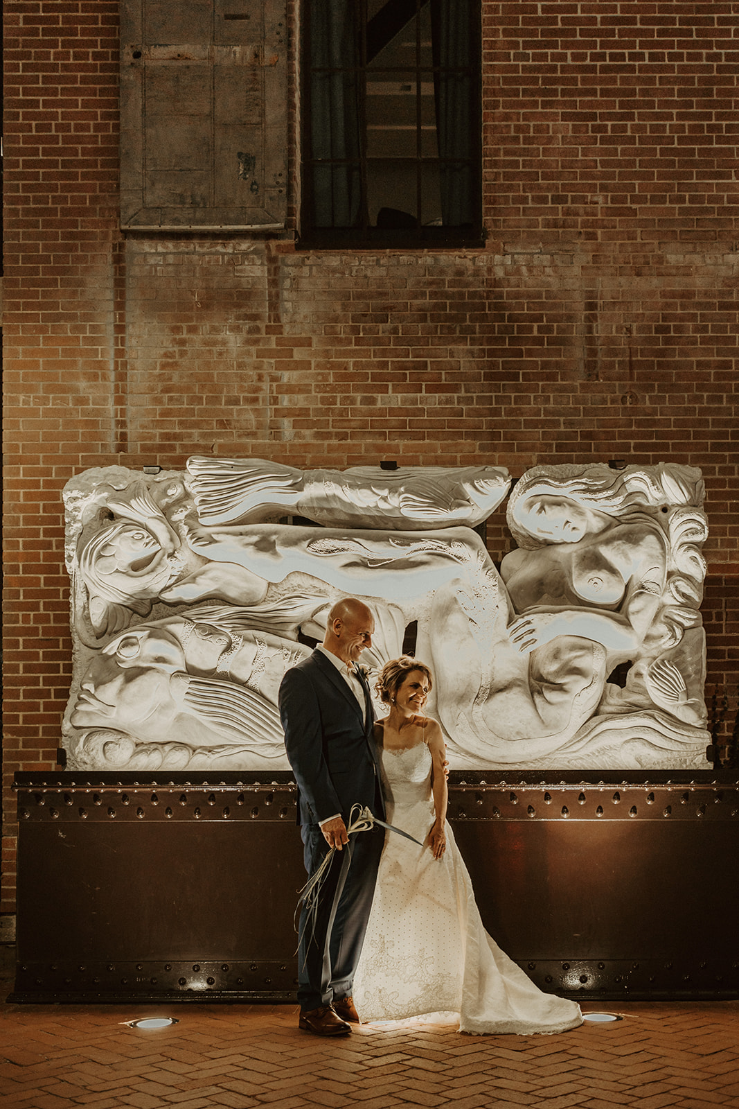 the bride and groom next to art 