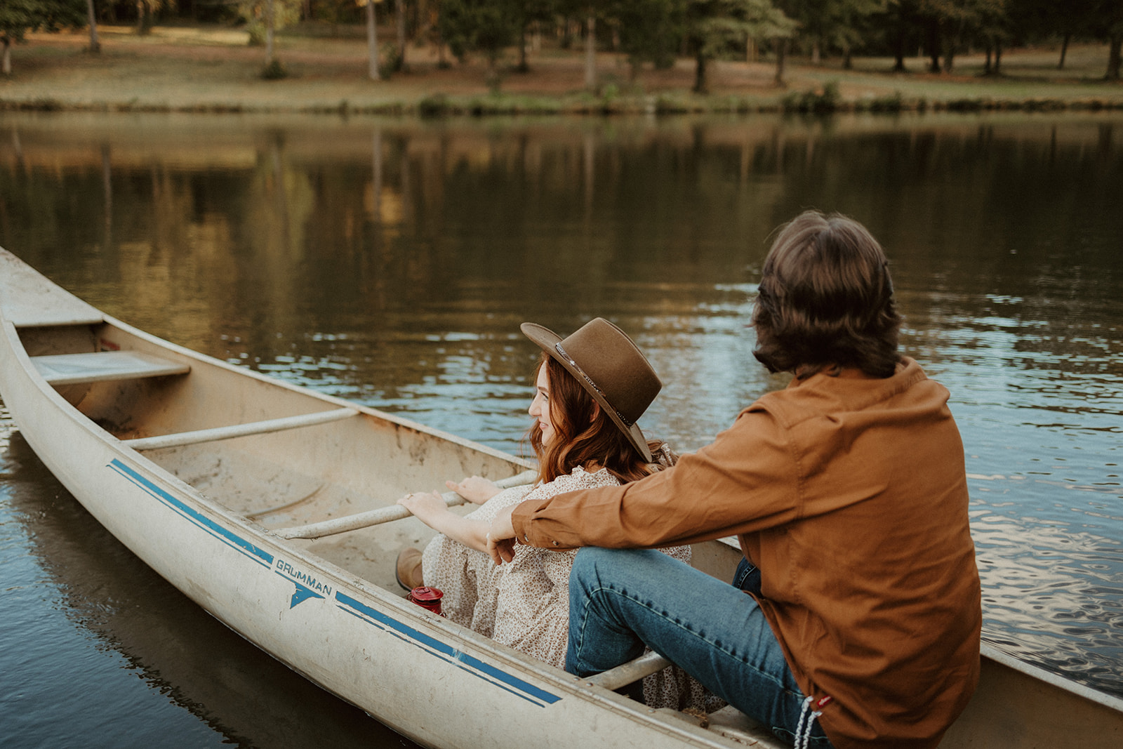 the couple floats on the lake in their canoe