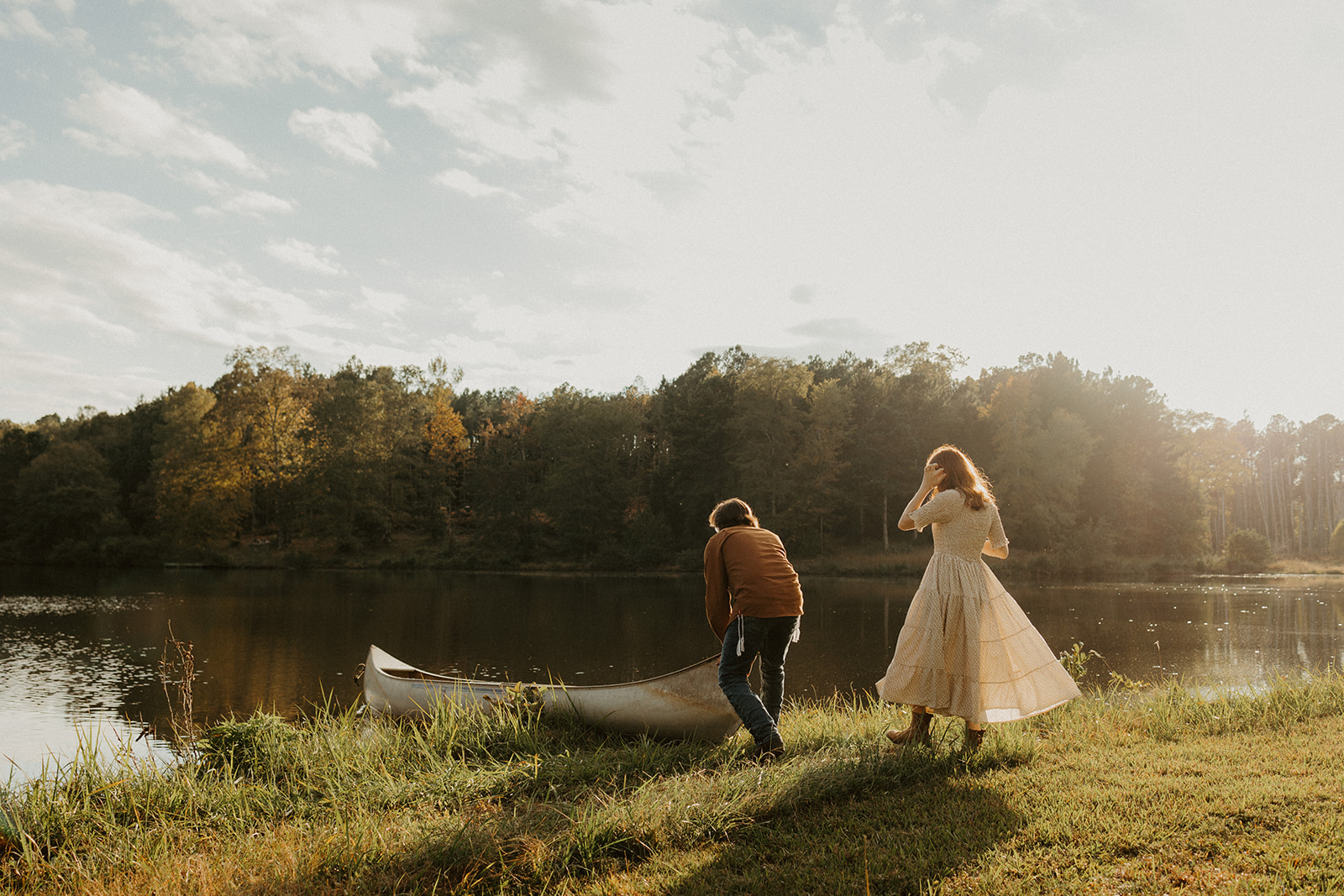 the husband and wife walk to their canoe