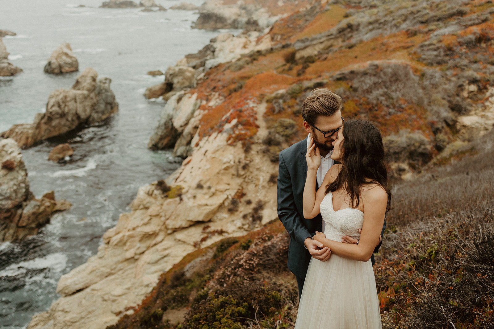 the bride reaching up and touching the groom's face