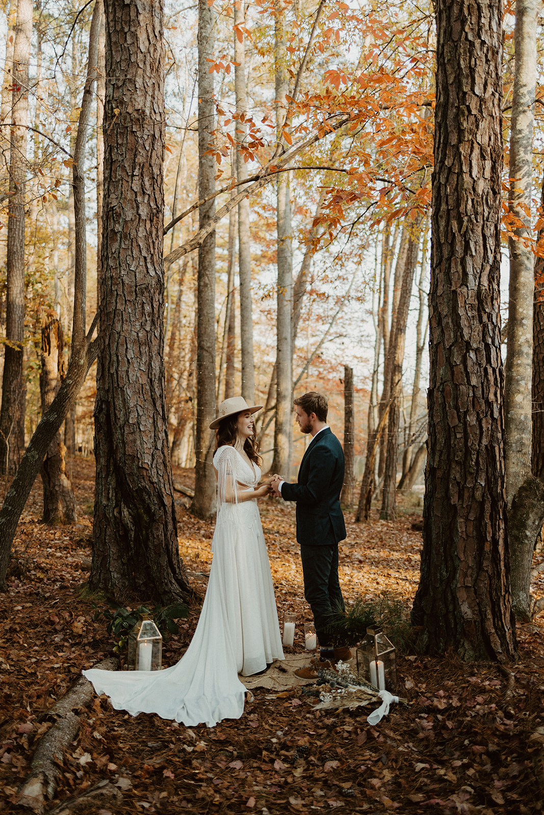 the couple standing together in the woods during their fall elopement in Georgia