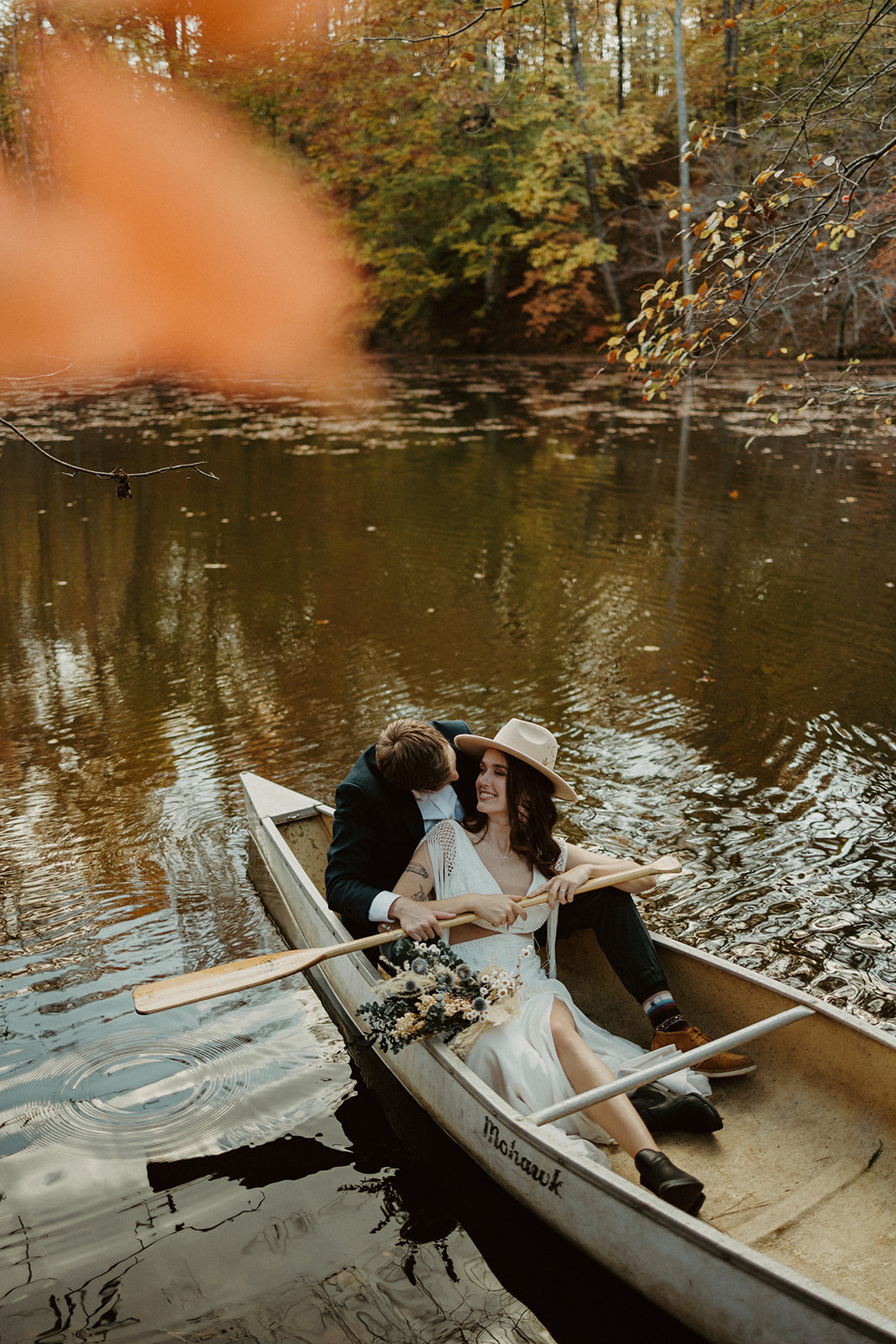 the couple sitting together in a canoe