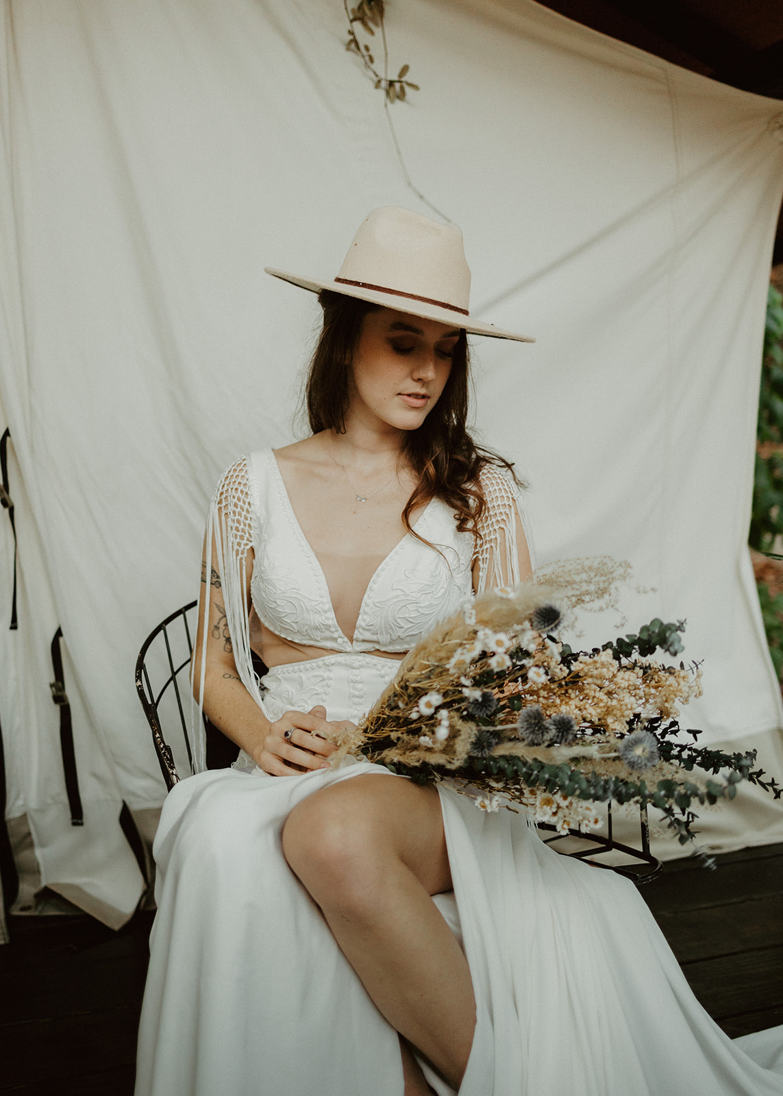 the bride sitting by the tent before her elopement in Georgia