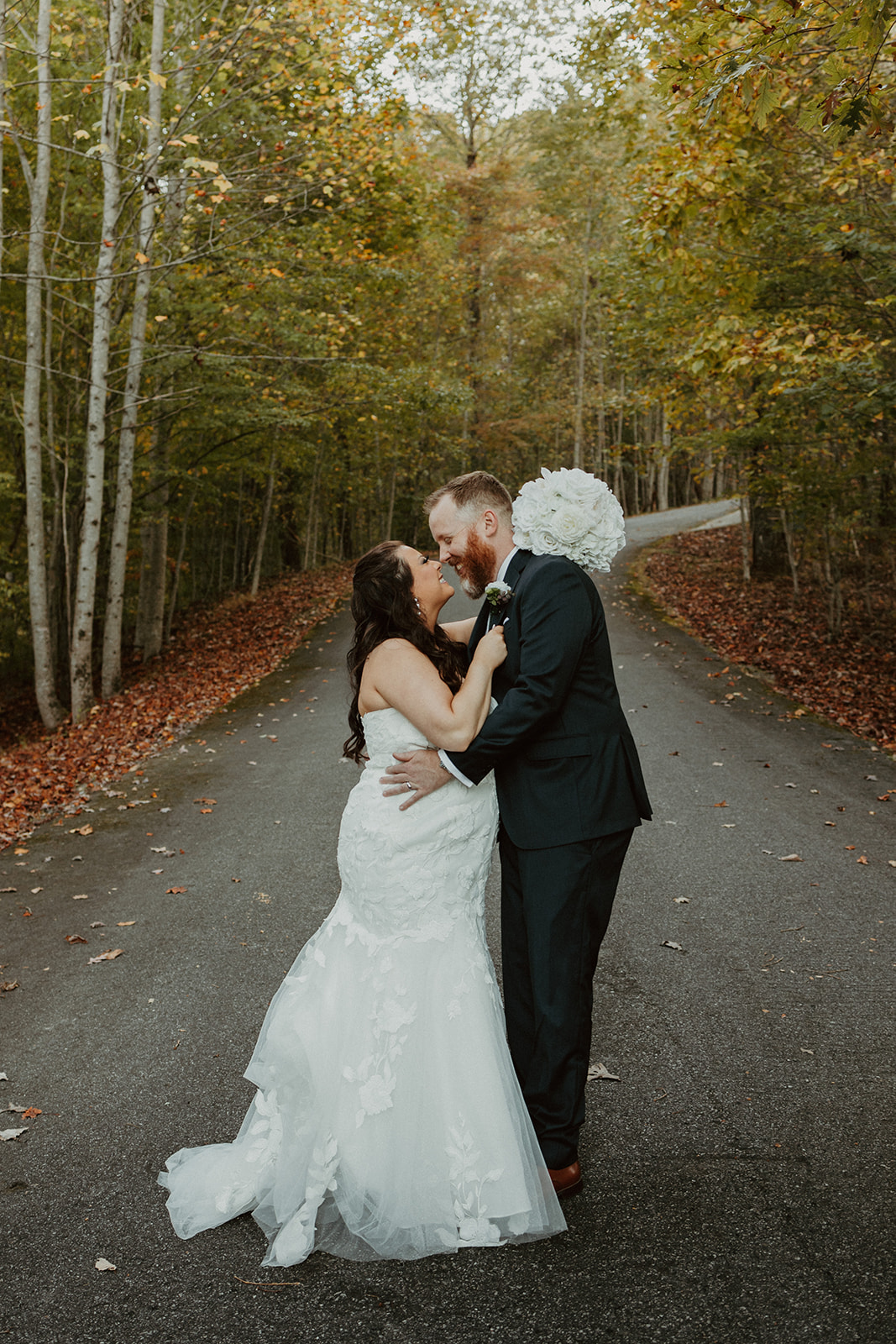 wedding couple in the fall trees at their airbnb wedding venue