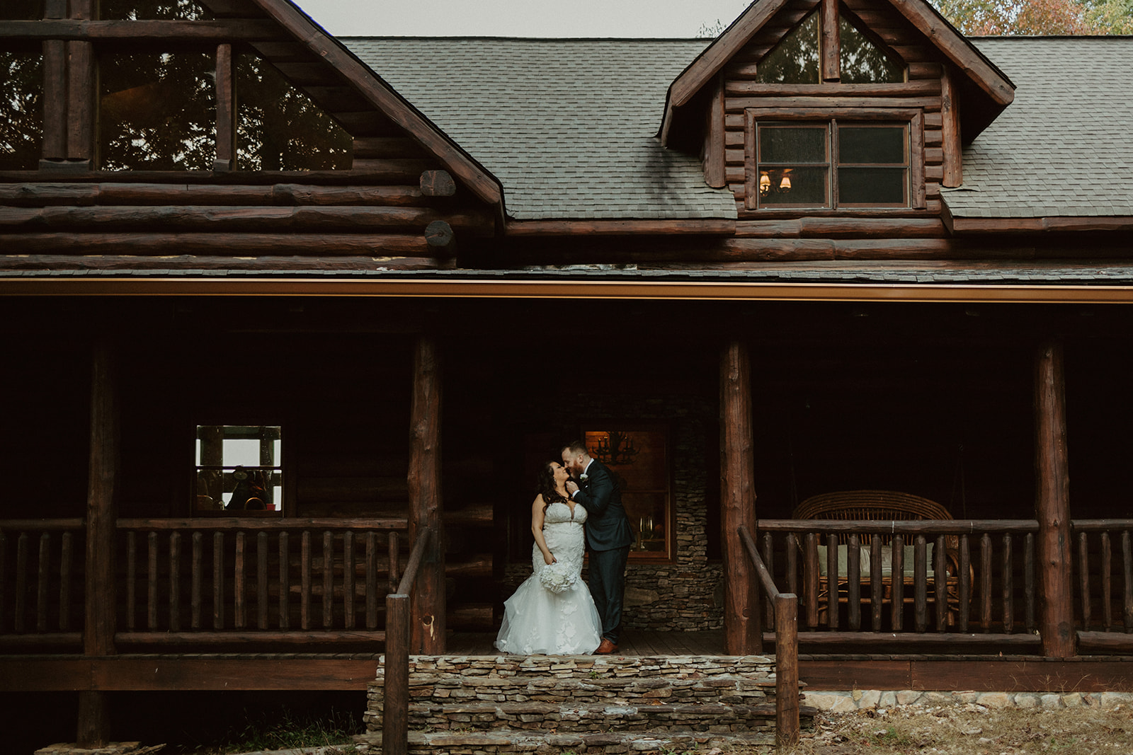 couple kissing on the porch of their airbnb wedding venue