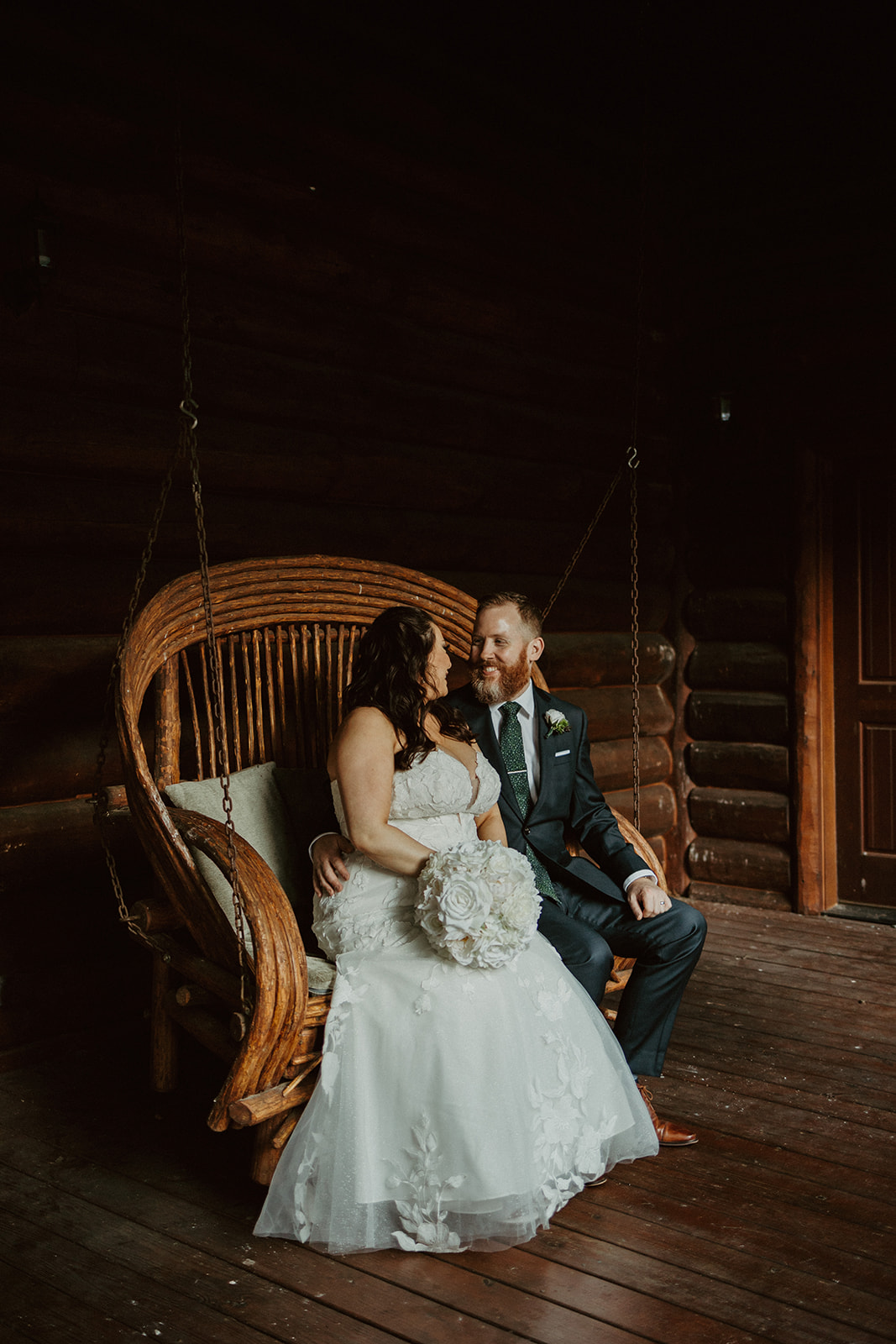couple sitting on fancy love seat at the airbnb wedding venue