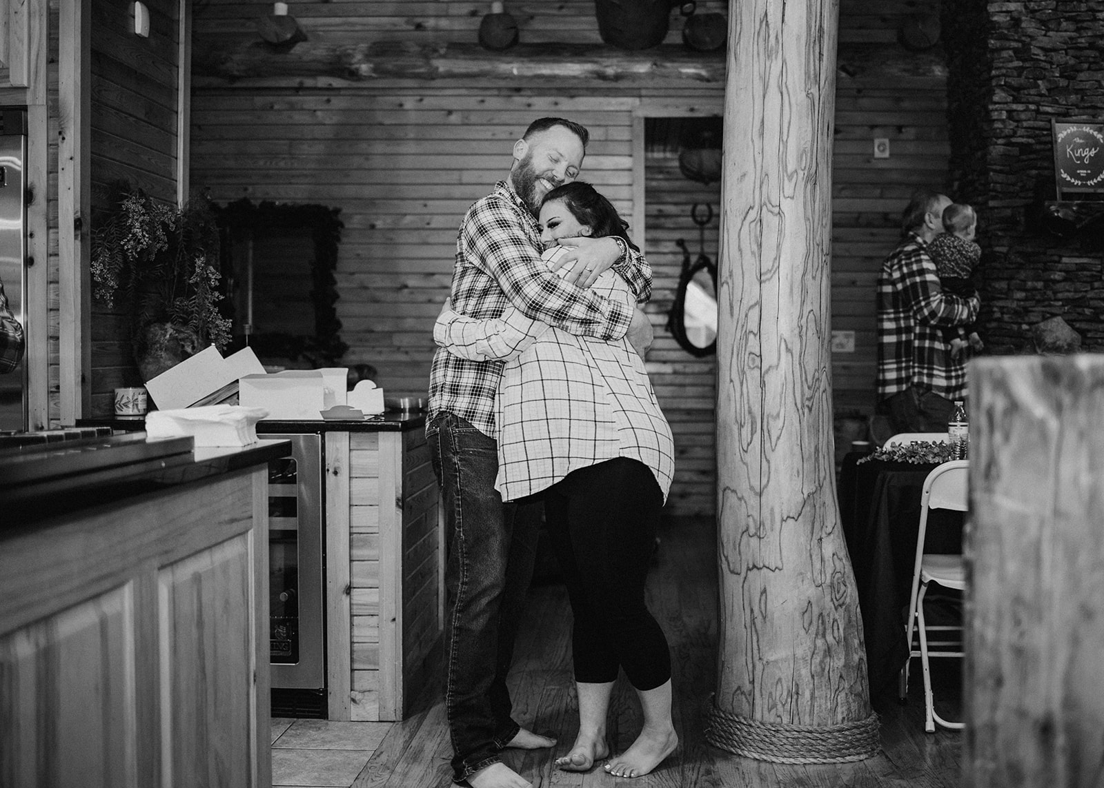 couple hugging each other in their flannel shirts