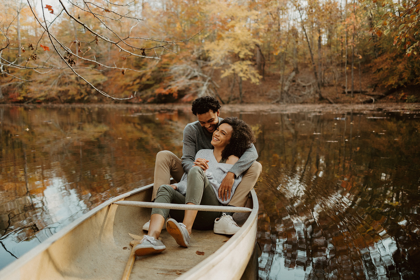 the couple sitting in a canoe as ideas for couple photoshoot