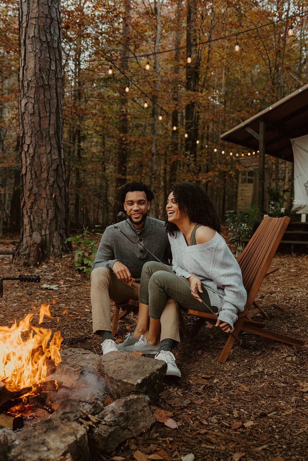 the couple sitting by the campfire