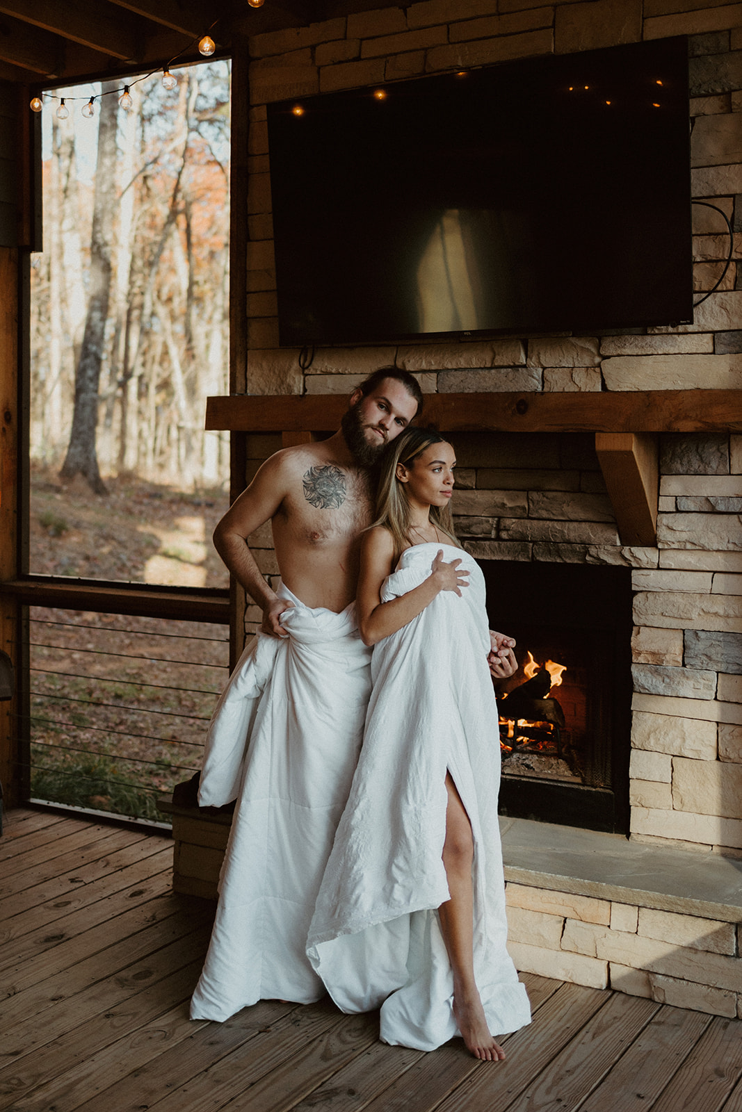 the couple standing in front of the fireplace