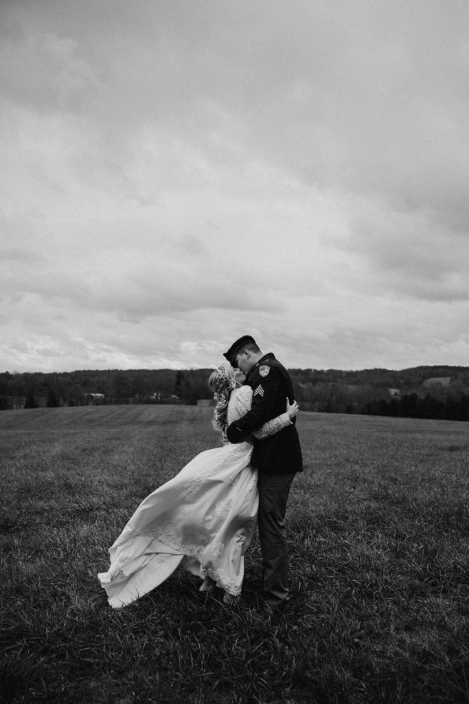the bride and groom kissing before the storm rolled in 