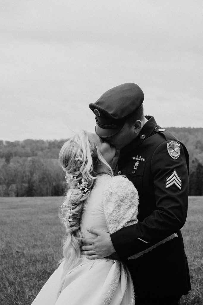 the bride and groom kissing before the storm rolled in for their intimate wedding