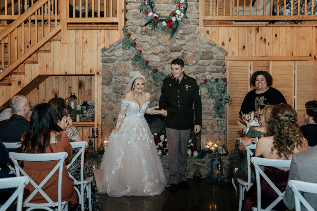 the bride and groom walking down the aisle as husband and wife