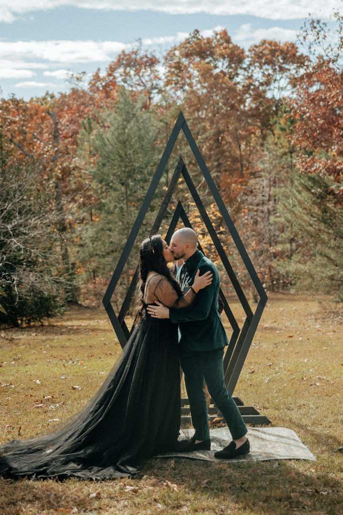 the bride and groom having their first wedding kiss during their intimate wedding ceremony