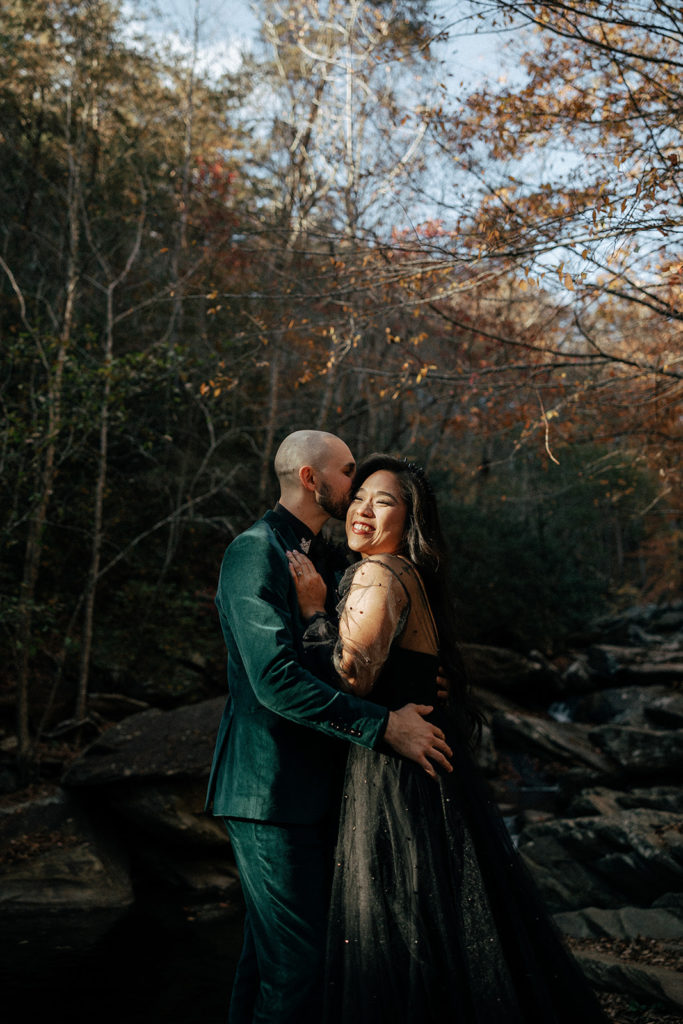 the groom kissing the bride's cheek during their elopement photos in Mineral Bluff