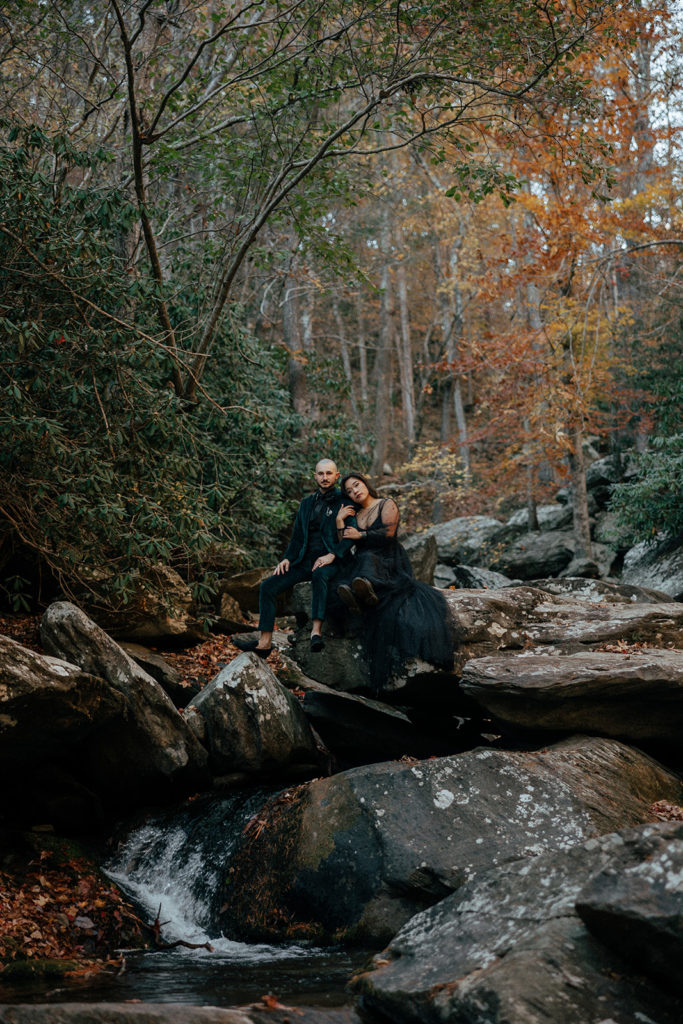 the bride and groom sitting on the mountain for elopement photography