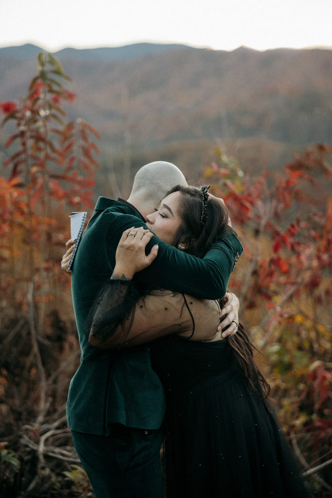 the bride and groom hugging during their adventure elopement in Mineral Bluff