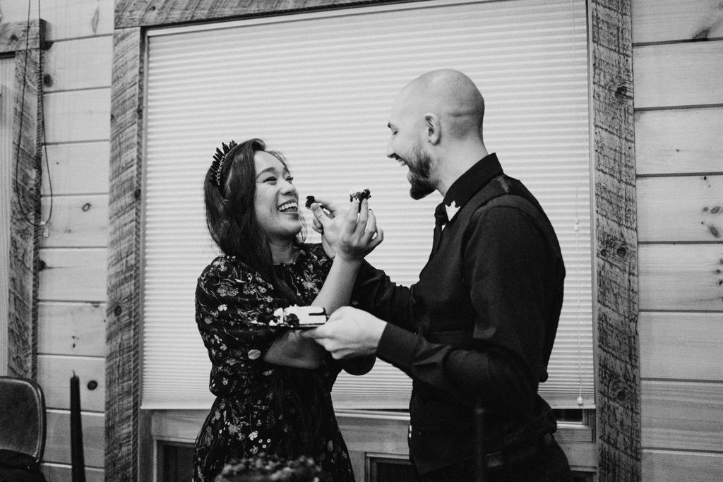 the bride and groom cutting the cake at their wedding during the wedding reception